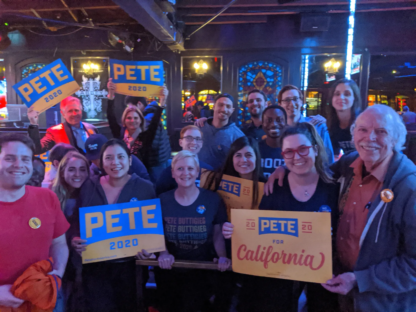 Los Angeles for Pete supporters holding signs together at a November 2019 debate watch party